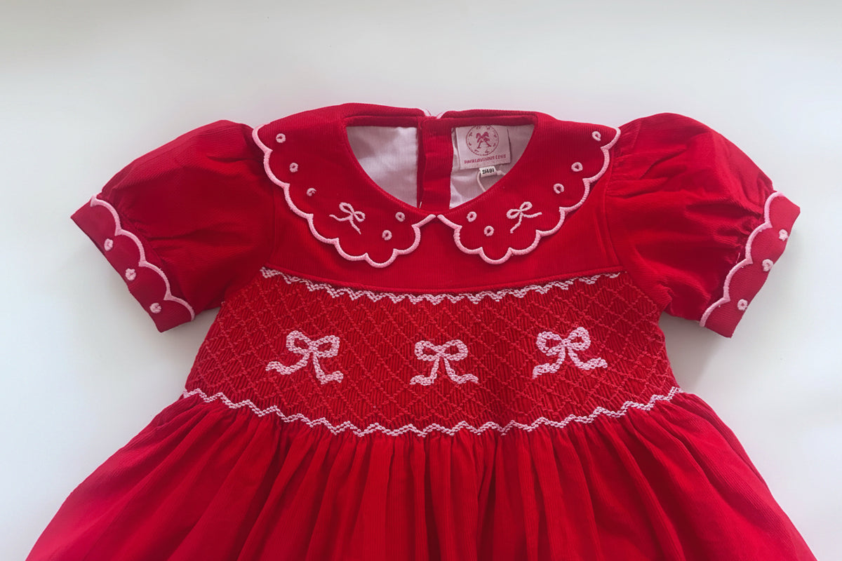 Red dress with white embroidery on a white background